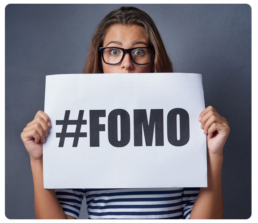 woman holding #fomo sign
